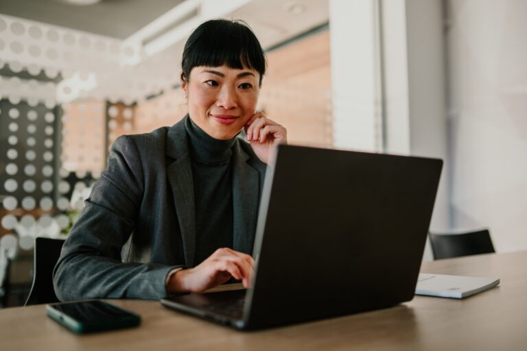 Businesswoman working on laptop in modern office